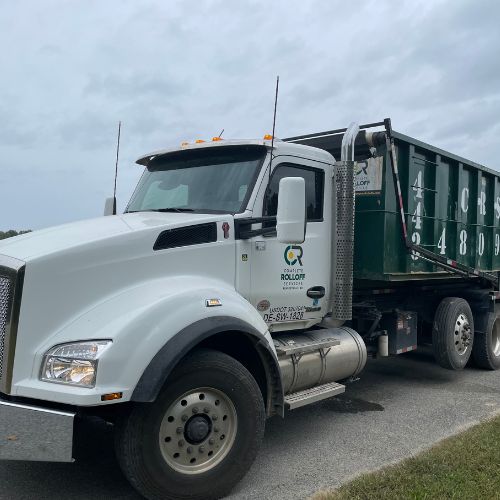 Complete Rolloff Services truck with a dumpster ready for a rental